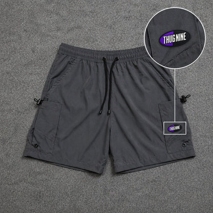 Short Cargo Streetwear Urban com Bolsos Laterais Cinza com patch Thug Nine Oval Preto Com Roxo